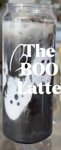 The BOO Latte in a clear can glass: dark mocha marbled with white cold foam, a ghost drawn on the side.