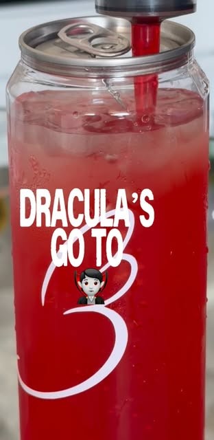 Dracula’s GO TO: a bright red cherry drink in a sealed can glass with a red straw and the Baglory heart.